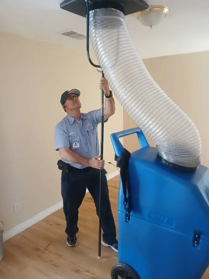 Furnace Tune-Up technician using HEPA equipment in Fair Lakes